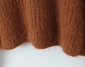 Close-up of caramel mohair cardigan fabric showing plush texture and knit detail