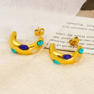 Detail of gold C-shaped hoop earrings featuring inlaid turquoise and colorful stones