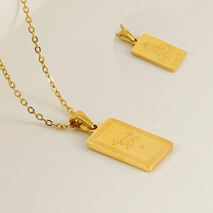 Detailed close-up of 18K gold-plated zodiac dog and Buddha pendant on a steel chain