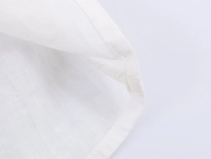 Close-up of white poplin shirt collar showing detailed beaded trim and premium stitching
