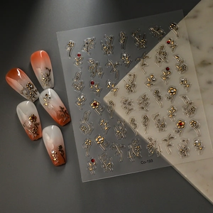 Detailed 3D gold embossed nail sticker with floral motifs and crystal embellishments