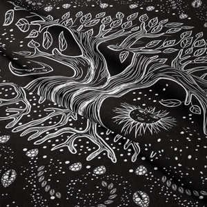 Macro shot of life tree tapestry showing high-contrast black and white print texture