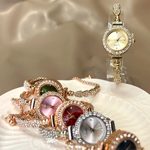 Close-up of elegant quartz watches with rhinestone-studded bezels and colorful dials