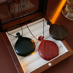 Three premium faux wood wine bag flask necklaces in black and brown on velvet lining