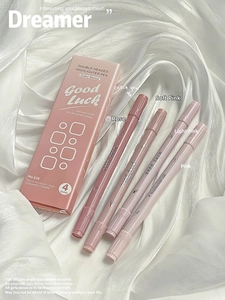 Detail showing set of four dual-tip pink highlighters on soft white silk background
