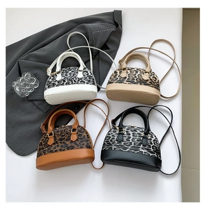 Top view of fashion shell handbags in four colors with leopard print and gold hardware