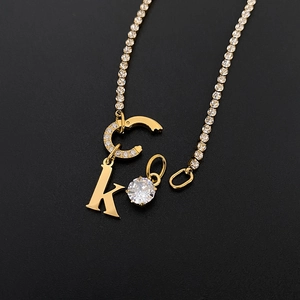 Detail view of 14K gold plated initial pendants with sparkling CZ stones.
