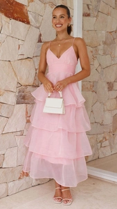 Detail of pink tiered ruffled evening dress with delicate thin straps and layered fabric