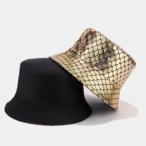 Detail of reversible bucket hat with shiny colorful fish scale pattern and black fabric