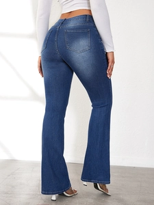 High-waisted flared jeans in dark blue shown from a back view to highlight the fit