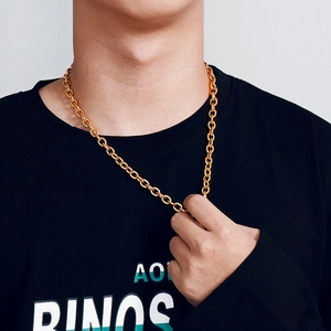 Close-up of a classic golden stainless steel cable chain worn on a male model's neck