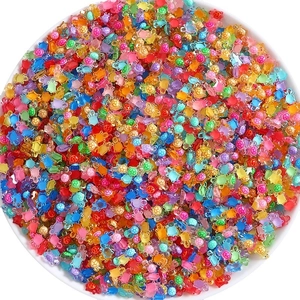 Vibrant mini resin turtles in multiple colors inside a white bowl for DIY crafts