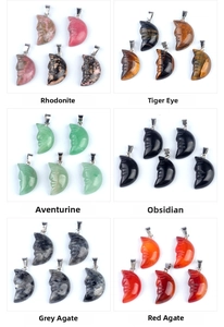 Detailed close-up of carved moon face pendants in various gemstones with metal bails