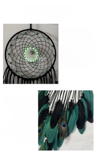 Detail of dream catcher featuring peacock feathers and luminous beads for wall decor