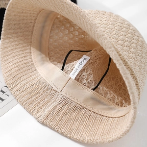 Detailed view of breathable crochet bucket hat interior with sweatband and drawstring