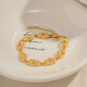 Macro detail of textured 18K gold plated stainless steel bracelet with lava texture