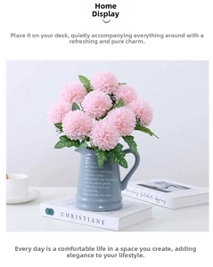 Pink artificial pompon flowers in a blue ceramic jug vase for Nordic home decoration
