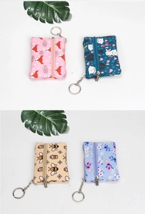 Detailed view of printed mini coin purses with metal keychains and floral animal patterns