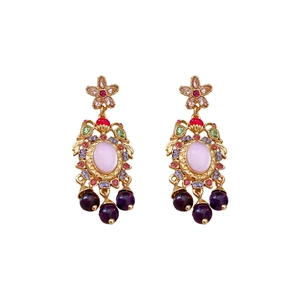 Vintage gold flower earrings with pink gemstone and colorful rhinestones on white backdrop