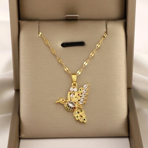 Colorful hummingbird pendant necklace with micro-pave cubic zirconia on a gold chain