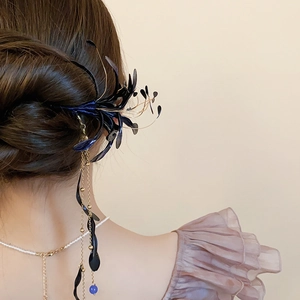 Detail of vintage flower hair stick with blue oil-drop petals and long elegant tassels