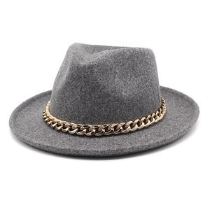Detail of dark grey wool felt fedora featuring a chunky gold metal chain link hatband