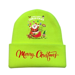 Close-up of neon green Christmas knitted hat with festive cartoon prints and embroidery