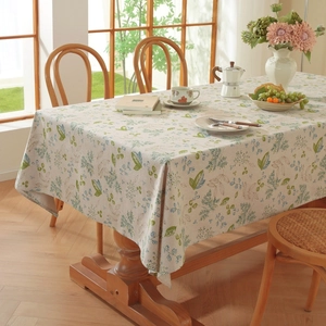 Close-up of vintage cotton linen tablecloth with blue floral and green leaf patterns