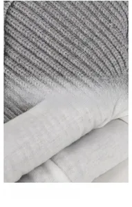 Close-up of thick grey knit fabric and soft white fleece lining for infant winter hat