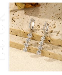 Detailed macro of S925 sterling silver drop earrings with floral zircon clusters