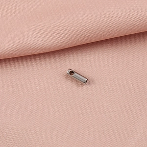 Vue détaillée d'un connecteur serpent en acier inoxydable argenté sur tissu rose