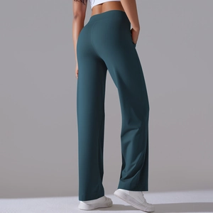 Detail of high waisted wide leg yoga pants featuring side pockets in dark teal green