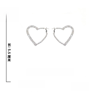 Detailed view of silver heart hoop earrings with rhinestones, 5.5cm size and 925 silver pins