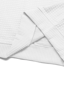 Macro view of white waffle knit fabric texture and ribbed cuff stitching details