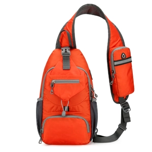 Detail of orange nylon outdoor sling bag featuring shoulder strap with mini phone pouch