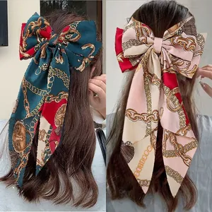 Detail showing vintage chain pattern bow hair clips in green and champagne colors
