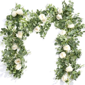 Detailed view of artificial ivory rose and eucalyptus vine garland on white background