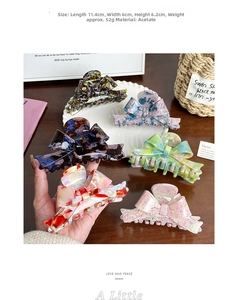 Detailed view of large acetate bow hair claw with marble texture and product dimensions
