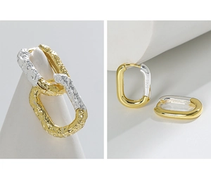 Detail of S925 sterling silver U-shaped earrings with lava texture and polished mirror finish