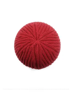 Top-down view showing deep red thick knit texture and radial pattern of the winter beanie