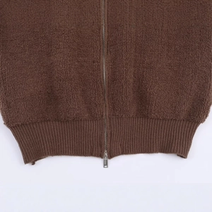 Deep brown sherpa bomber jacket featuring textured fabric and durable metal zipper