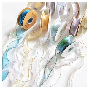 Close-up of shimmering organza ribbons in champagne, blue, and purple for Christmas decor