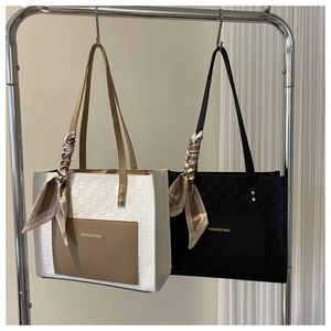 Detail of tote bag with woven texture, silk scarf decor and Fashion Bag logo