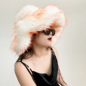 Detail of oversized white faux fur bucket hat with vibrant orange tips and fluffy texture