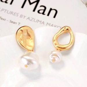 Asymmetric gold baroque pearl drop earrings featuring irregular round and hollow metal designs