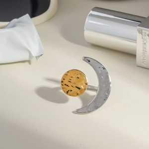 Detailed view of sun and moon open ring featuring hammered gold and silver textures