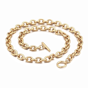 Golden paperclip chain necklace with OT buckle and T-bar toggle clasp on white background