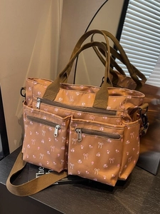 Brown corduroy tote bag with pink floral patterns and a detachable shoulder strap