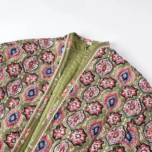 Detailed view of S-size ethnic print quilted jacket with gold braided trim and green fabric