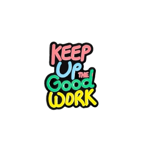 Detail showing colorful enamel badge with KEEP Up THE GOOD WORK motivational quote